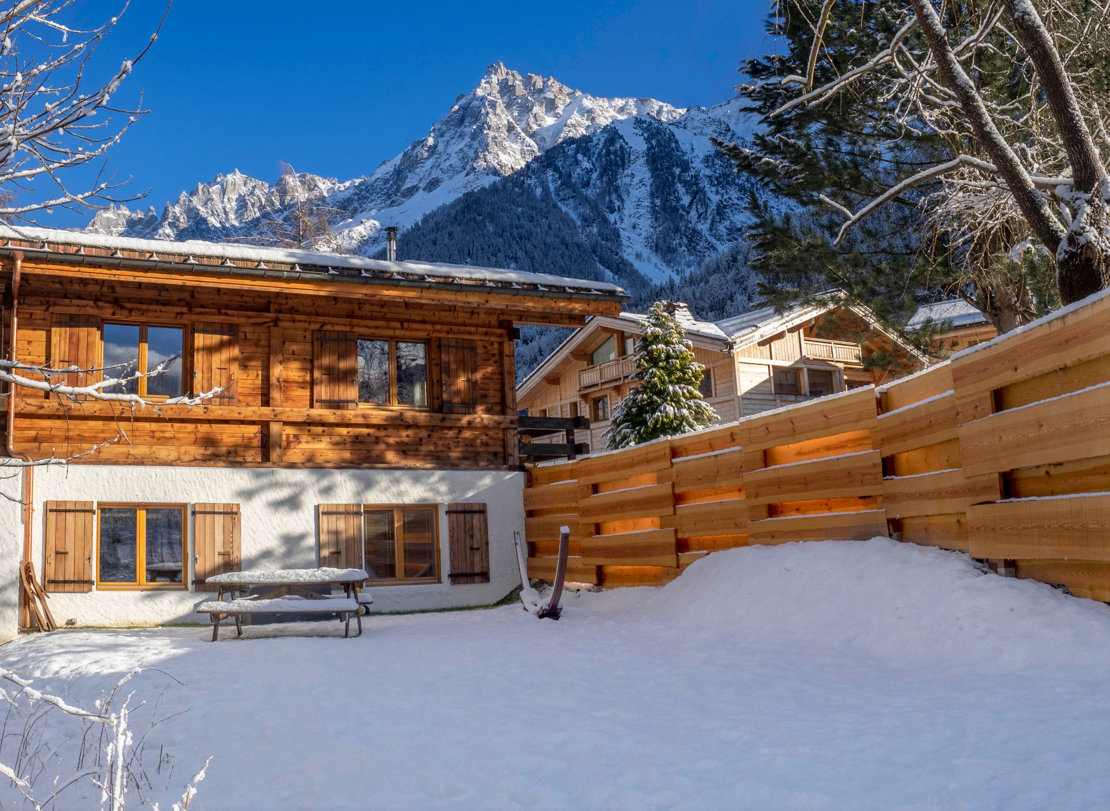 The chalet in winter beneath the mountains
